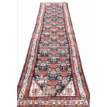 ANTIQUE PERSIAN MALAYER RUNNER, 390cm x 90cm, all over floral field within corresponding borders.