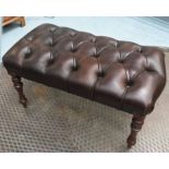 FOOTSTOOL, deep buttoned brown leather upholstered, raised on turned walnut supports,