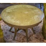 LOW TABLE, circular, in a distressed effect green painted finish, with carved and swagged detail,