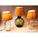 LAMPS, a pair, vintage clear glass flagons, together with a single large green glass flagon,