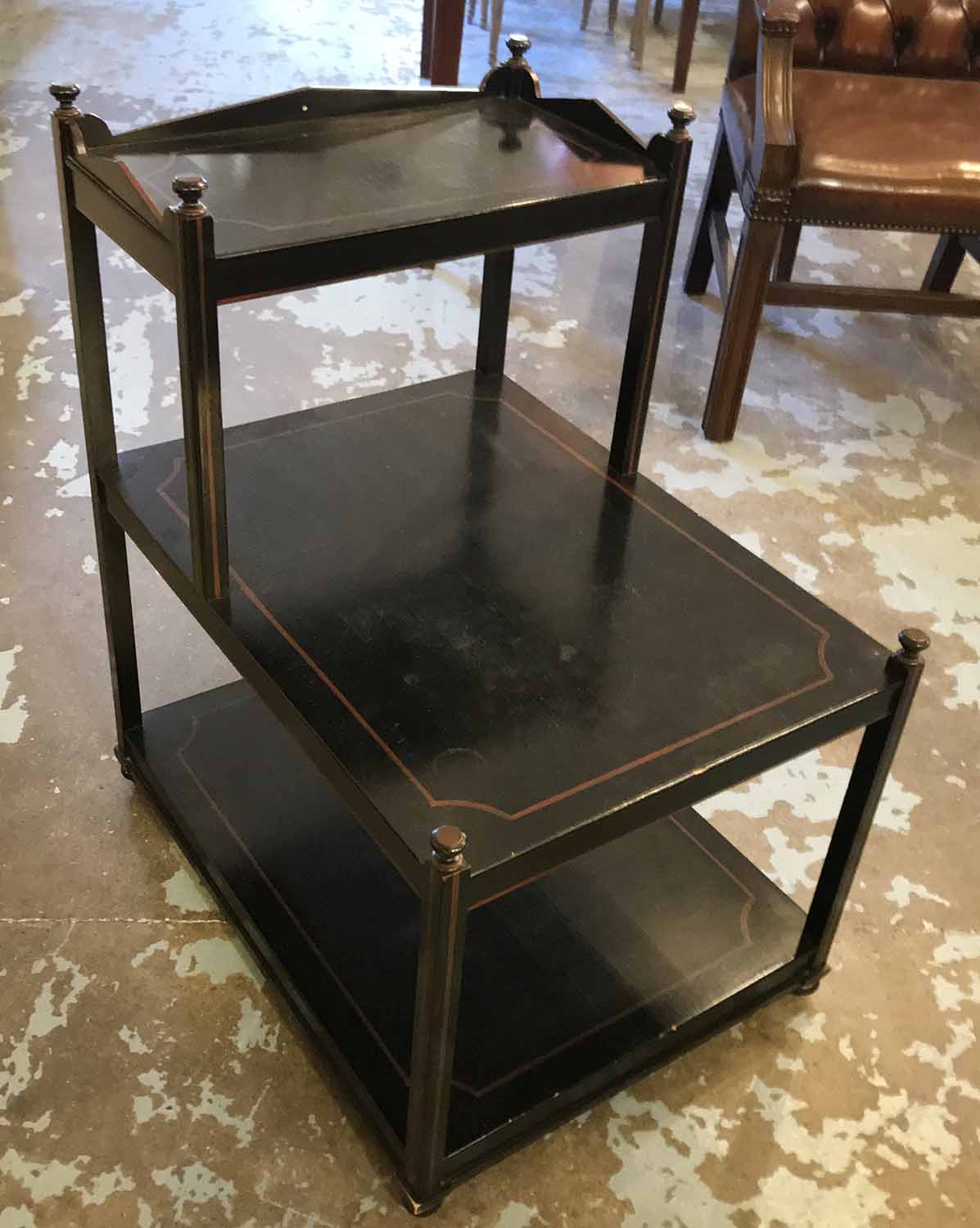 WILLIAM YEOWARD SIDE TABLE, three tiered in an ebonised and line painted finish,
