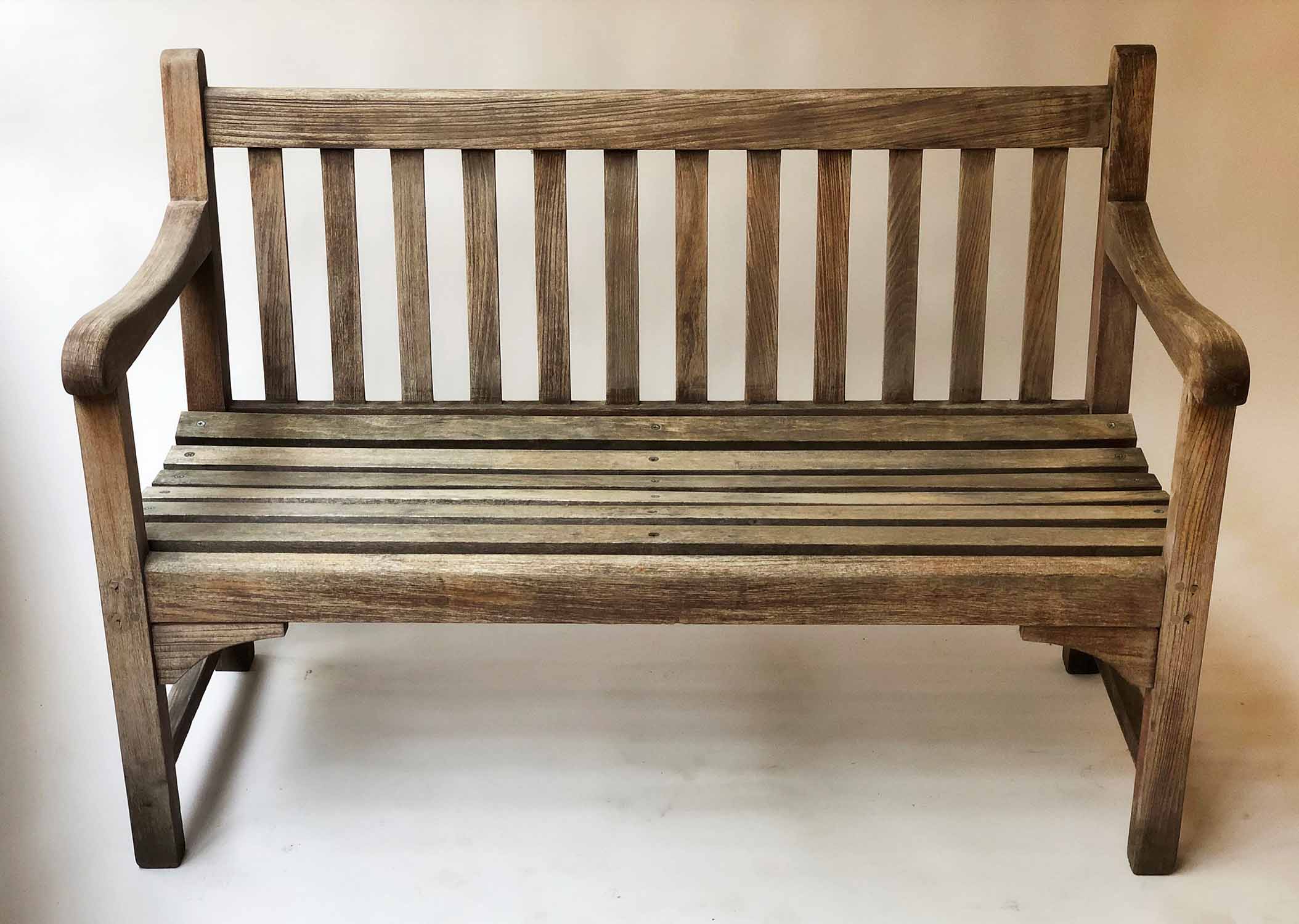 GARDEN BENCH, silvery weathered teak of slatted construction, 122cm W.