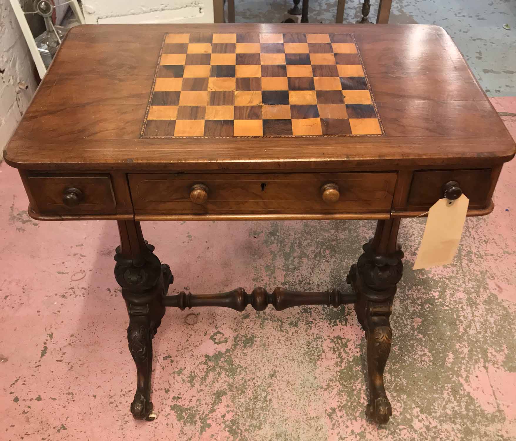 GAMES TABLE, Victorian walnut with inlaid top over three frieze drawers, raised on carved supports,