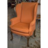 WINGBACK CHAIR, Queen Anne style in orange woven fabric on carved cabriole front supports,