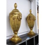 HOLLYWOOD REGENCY STYLE URNS, a pair, gilt finish, 90cm.