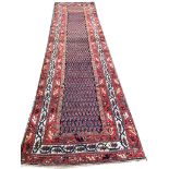 ANTIQUE MALAYER RUNNER, 387cm x 90cm, all over boteh design within repeat matching borders.