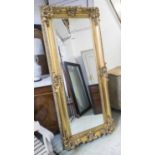 WALL MIRROR, Continental style gilt rectangular swept frame, 197cm x 85cm.