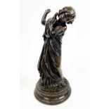 BRONZE OF A GIRL HOLDING A DOVE, stamped, '77.14', 24cm H.