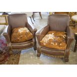 CLUB CHAIRS, a pair, early 20th century, in brown leather with studded detail and hide seats,