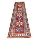 FINE SHIRVAN RUNNER, 302cm x 76cm, row of geometric medallions within corresponding borders.