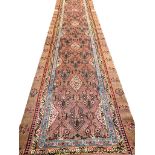 ANTIQUE SERAPI RUNNER, 550cm x 110cm, stylised botanic field within corresponding borders.