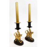 CANDLESTICKS, a pair, gilt bronze winged beasts, 18cm H.