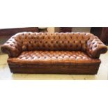 CHESTERFIELD SOFA, hand finished buttoned tan leather upholstery on short metal castors,