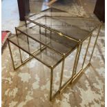 NEST OF TABLES, circa 1970's brass and smoked glass, largest 46cm H x 55cm x 37cm.