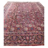 ANTIQUE KASHAN CARPET, 370cm x 260cm, all over design on a ruby field within corresponding borders.