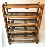 BAKERS RACK, early 20th century pine with five slatted shelves and castors, 100cm x 140cm H x 40cm.