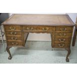 KNEEHOLE DESK, George III style mahogany, circa 1900, with brown leather top above nine drawers,