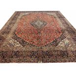 FINE SIGNED PERSIAN KASHAN CARPET, 377cm x 300cm, central medallion on a ruby field,