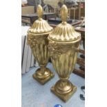 HOLLYWOOD REGENCY STYLE URNS, a pair, gilt finish, 90cm.