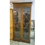 TALL BOOKCASE, Edwardian mahogany, with a pair of astragal glazed doors and adjustable shelves,