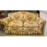 SOFA, in loose rose patterned covers, with seat cushions, on beech feet and castors, 183cm W.