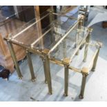 NEST OF THREE TABLES, Hollywood Regency style design, brass and glass, largest 41cm x 64cm x 49cm H.