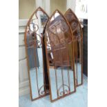 WALL MIRRORS, a set of three, French Provincial style, worked metal design frames, 115cm x 40cm.