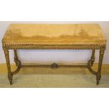 STOOL, circa 1900, French giltwood, in gold dralon, 94cm W x 38cm D (with faults).