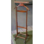 LOUIS VUITTON VALET STAND, circa 1920, stained beech on castors, 108cm H x 44cm.