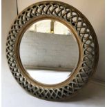 WALL MIRROR, circular bevelled plate within a silvered and gilt pierced frame, 118cm diam.