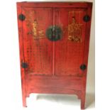 MARRIAGE CABINET, Chinese, scarlet lacquered, with two script decorated panelled doors,