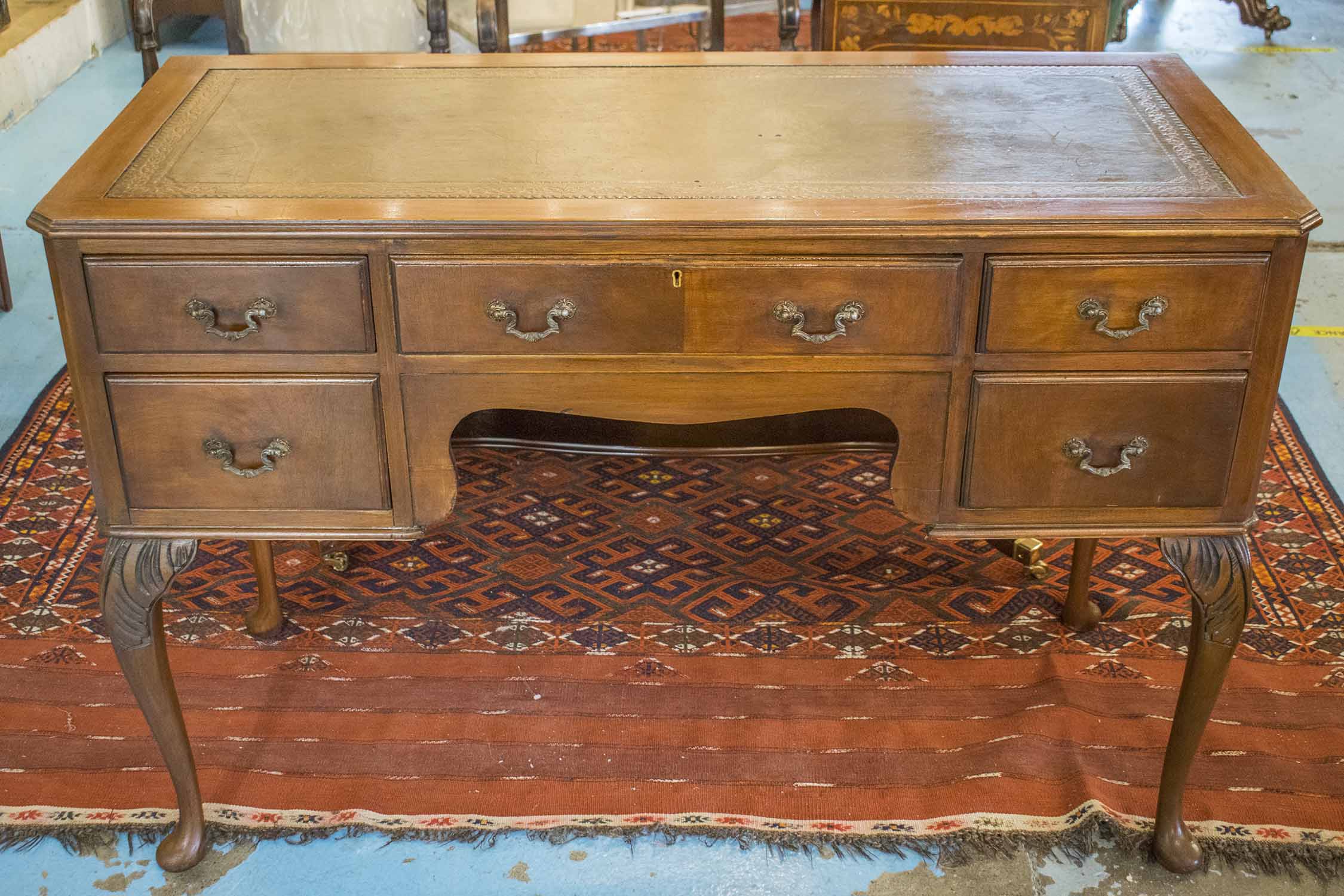 WRITING TABLE, early 20th century Georgian style mahogany with green leather top above five drawers,