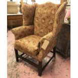 WING ARMCHAIR, 19th century mahogany, upholstered in red and gold print fabric,