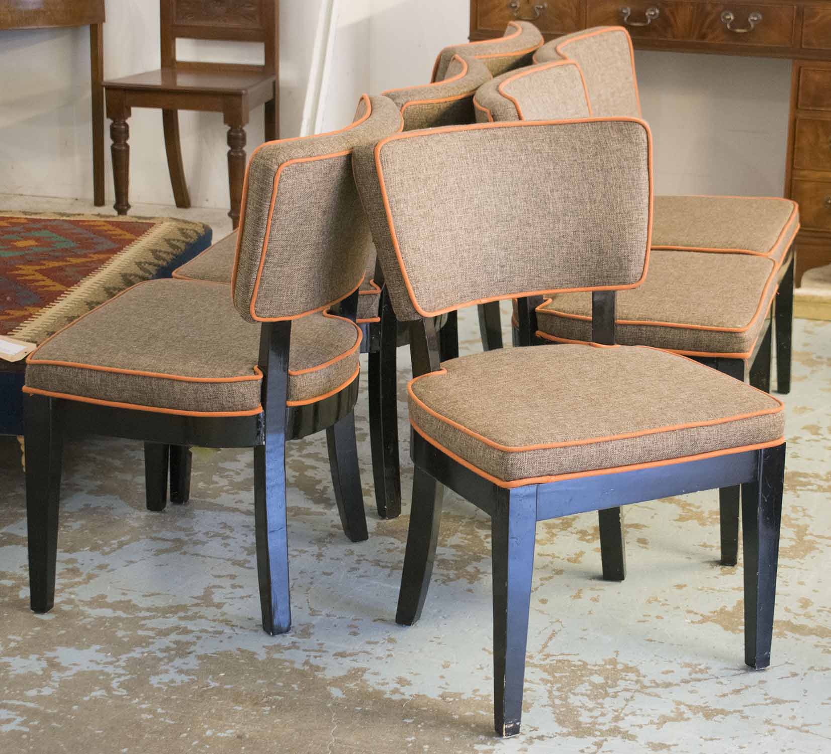 DINING CHAIRS, a set of six, black lacquered in brown fabric with orange piping.