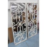 GARDEN MIRRORS, a pair, worked metal trellis design, 128cm x 48cm.