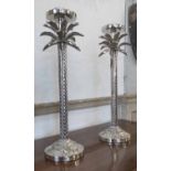 CANDLESTICKS, a pair, silver plated cast as palm trees 55cm H.