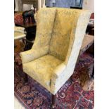 WINGBACK ARMCHAIR, 19th century with a tall back on square tapering supports and castors,