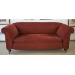 CHESTERFIELD SOFA, Victorian oak, in dark red chenille on brass castors,