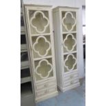 TALL GLAZED CABINETS, two in slightly differing shades of cream, each 56cm W x 30cm D x 188cm.