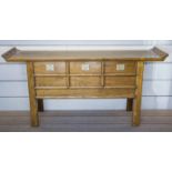 SCRIBES TABLE, Chinese elm with rattan top above three drawers, 86cm H x 173cm x 43cm.