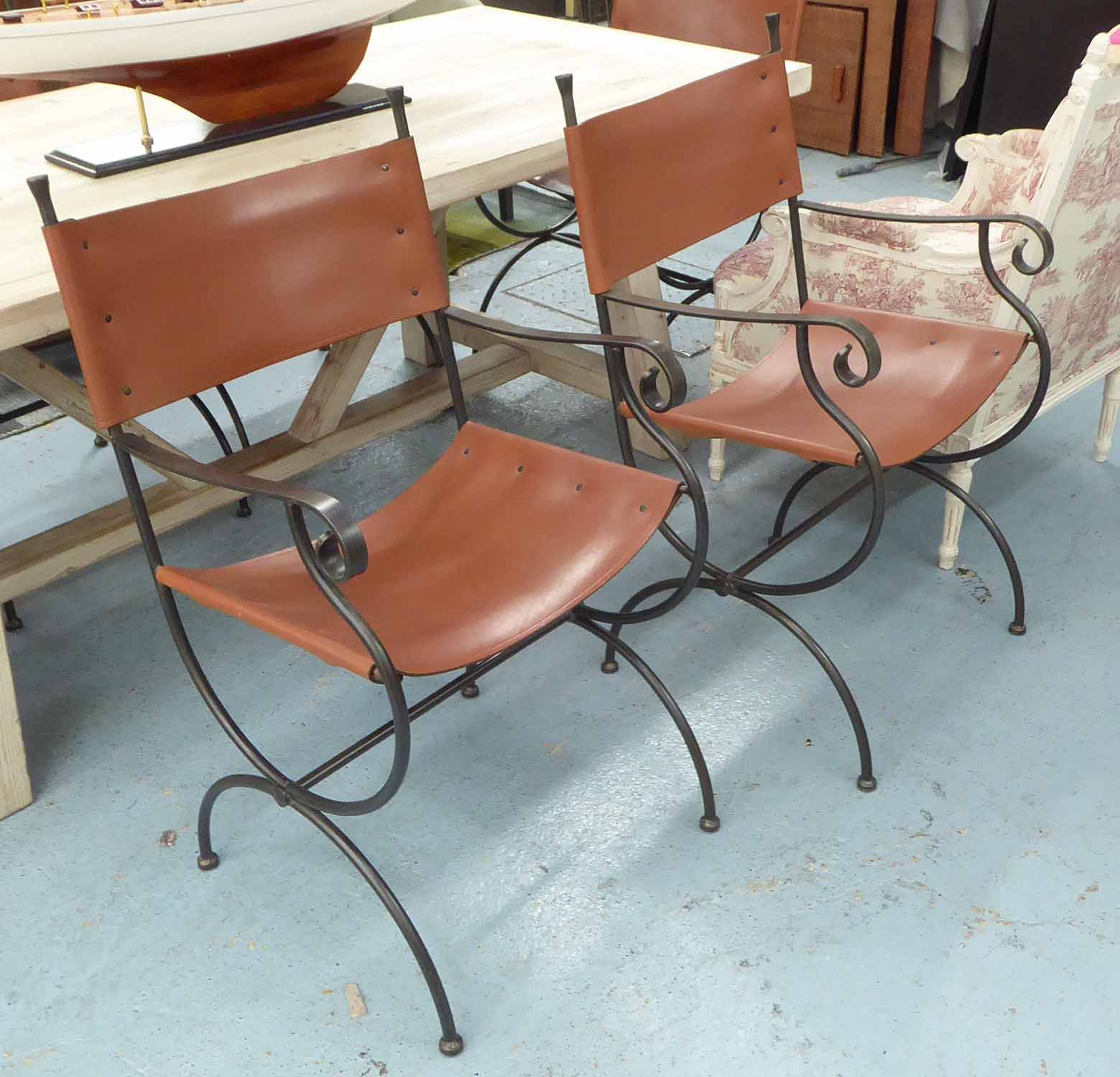 DINING CHAIRS, a set of six, metal frames with brown leather backs and seats, 53cm x 95cm H.