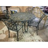 GARDEN DINING SET, green metal with pierced circular top 73cm H x 124cm and a set of four armchairs.
