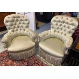 BERGERES, a pair, Napoleon III manner beechwood in tasseled and buttoned pale green silk on castors,