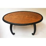 LOW TABLE, 19th century Ceylonese oval satinwood and carved ebony moulding and shaped supports,