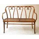 HALL SEAT, Thonet style bent fruitwood with scroll decorated back and cane panelled seat, 156cm W.