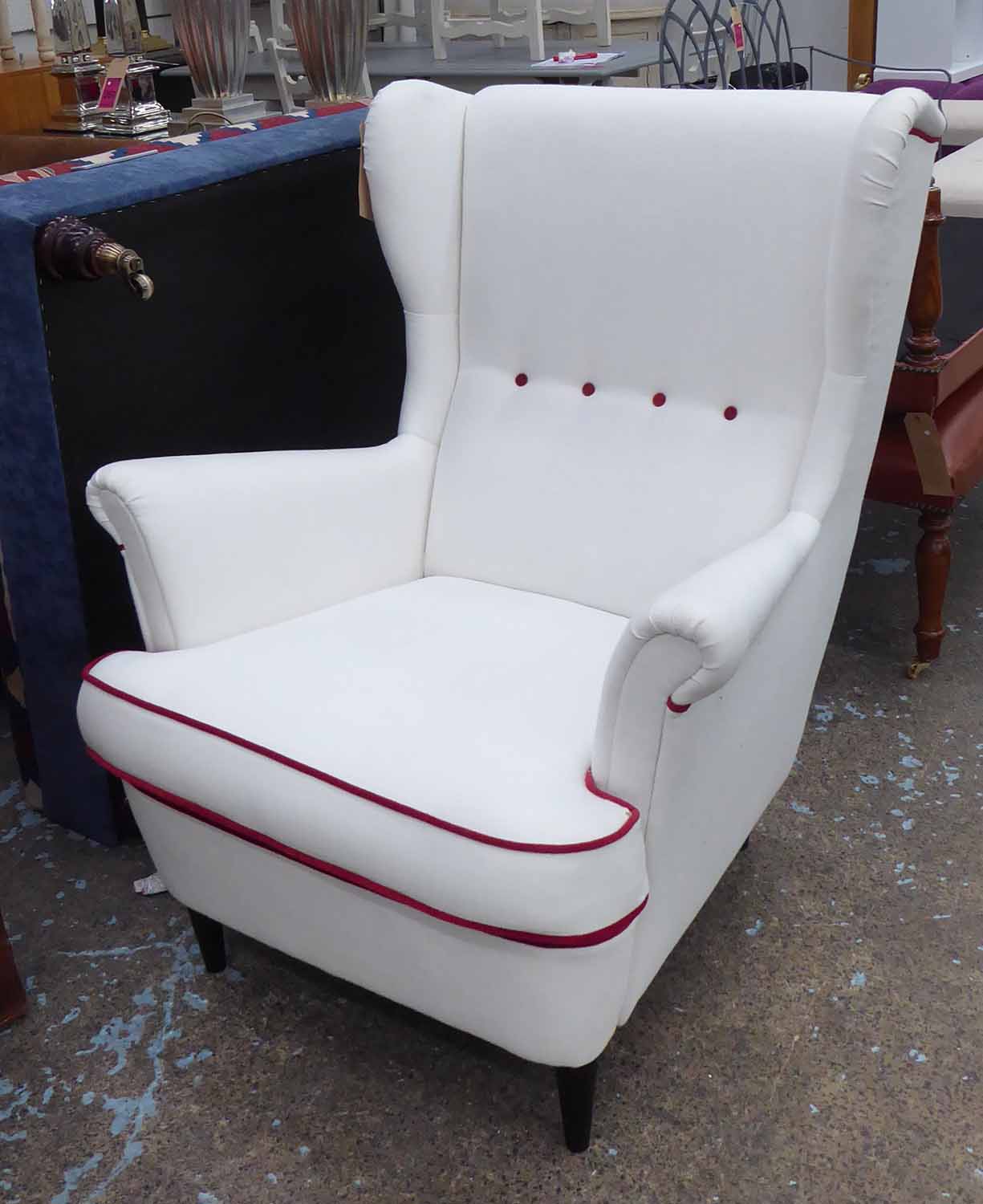 WING BACK ARMCHAIR, 1960's Italian style white with red button and piping detail, 100cm x 84cm W.
