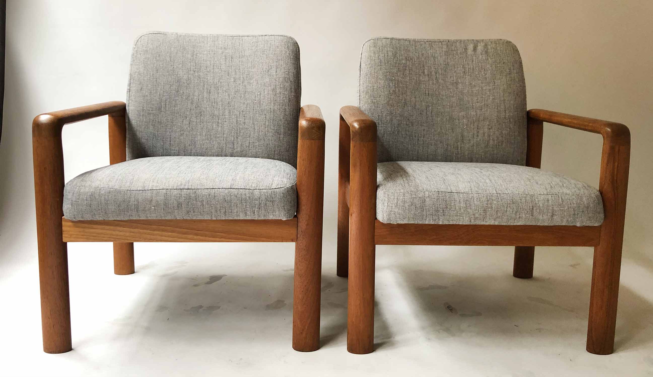 ARMCHAIRS, a pair, 1970's teak re-upholstered in grey herringbone weave cotton, 67cm W.