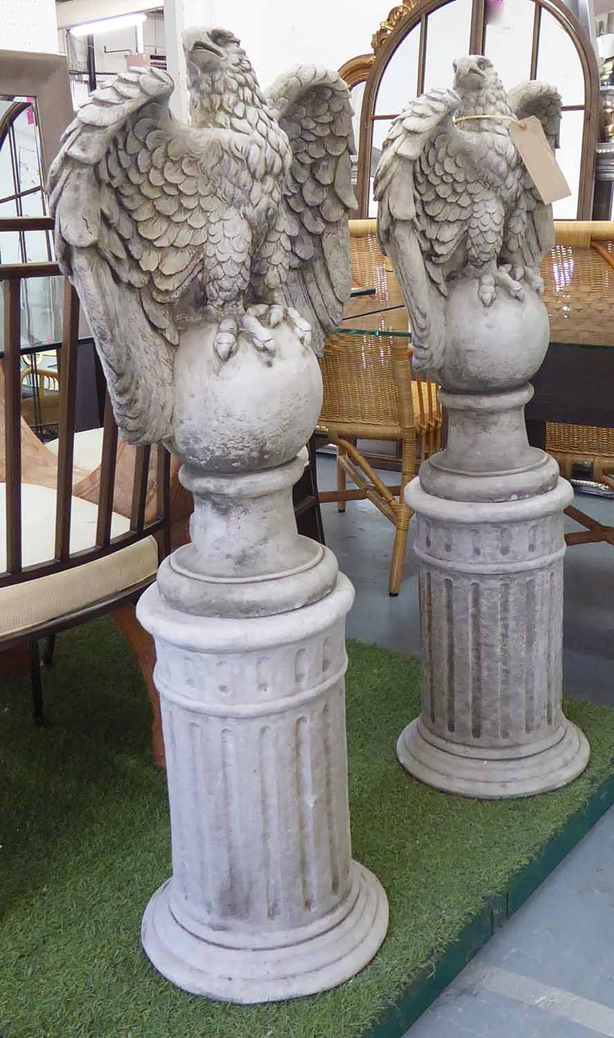 COMPOSITE STONE EAGLES, a pair with Corinthian column bases and ball finials, 121cm H.