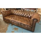 CHESTERFIELD SOFA, mid 20th century in deep buttoned tan leather upholstery raised on castors,