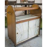 COCKTAIL TROLLEY, circa 1950 walnut and eglomise with two sliding doors, 81cm H x 77cm x 39cm.
